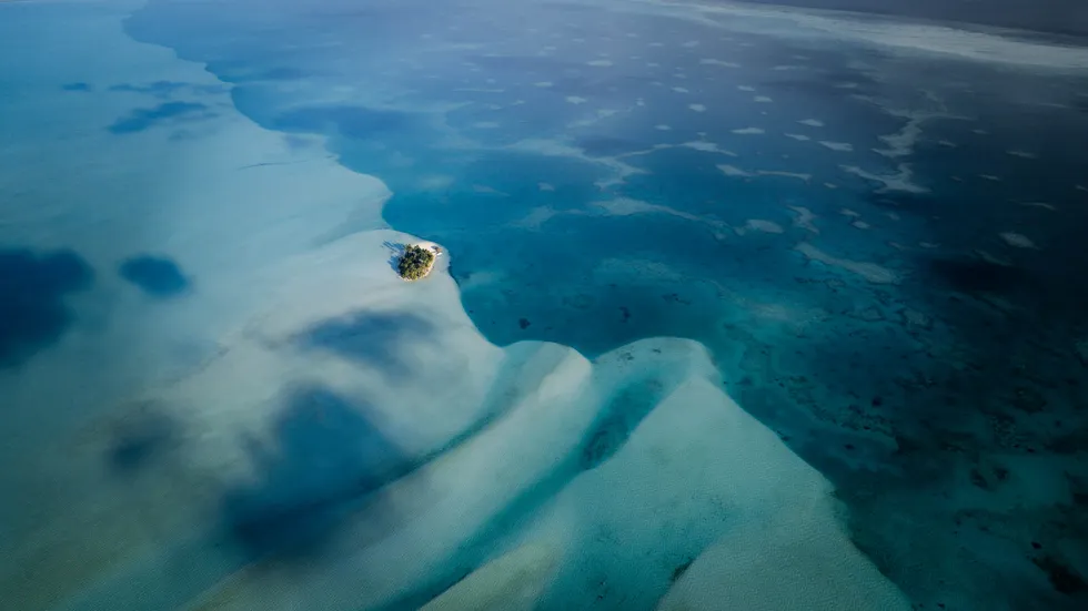 Aerial view of a tiny island and sandbanks in the Ayau atoll, Raja Ampat