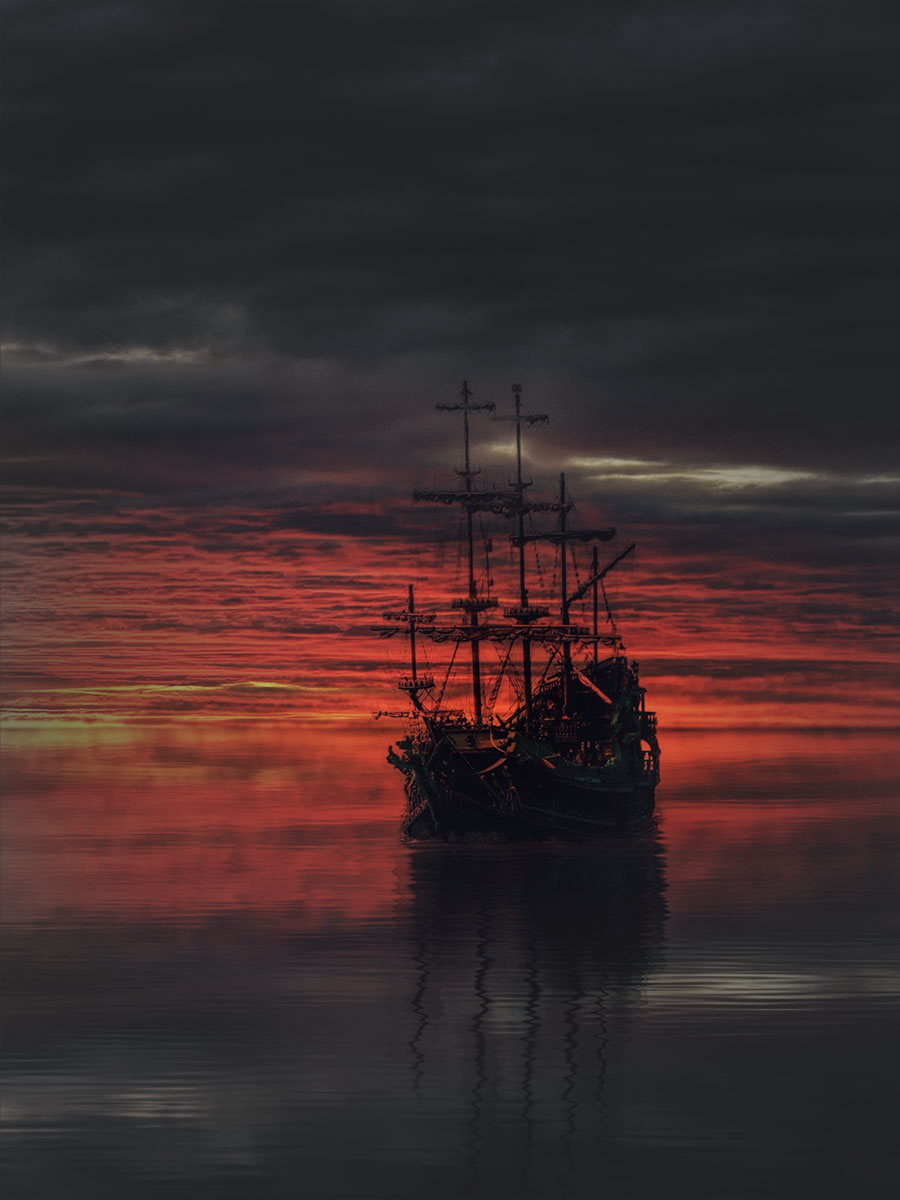 Old European Sail Ship in front of setting sun