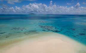 White sandbank surrounded by coral reefs in Ayau, Raja Ampat