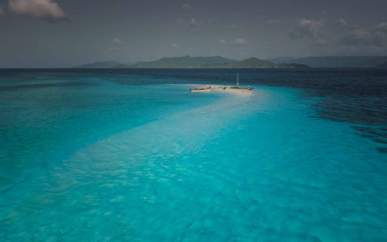 White sandbank surrounded by turquoise water